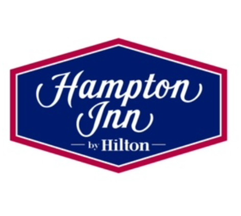 A blue and red sign that says hampton inn by hilton.